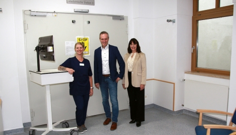 Saskia Hennig, Stationsmanagerin der noch nicht freigegebenen Station 3 (Eröffnung angepeilt im Q1 2026) und der Interimsstation 1 mit einem Visitenwagen und Herrn Landrat Jürgen van der Horst sowie Geschäftsführerin Anne Bülling vor der noch verschlossenen Tür der Station 3